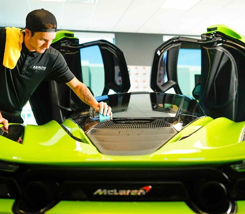 AZ Auto Aesthetics detailing technician applying a Clear Bra on a McLaren