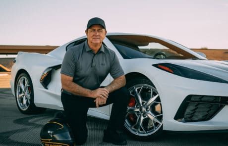 Mike McGovern kneeling next to car