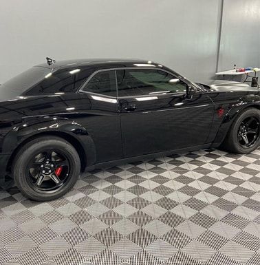 Automotive detailing shop black car side view