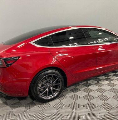 Automotive detailing shop red car side view