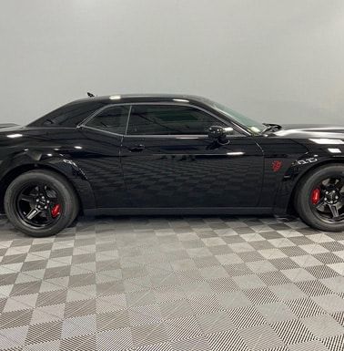 Automotive detailing shop black car profile view