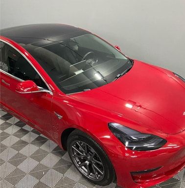 Automotive detailing shop red car front view