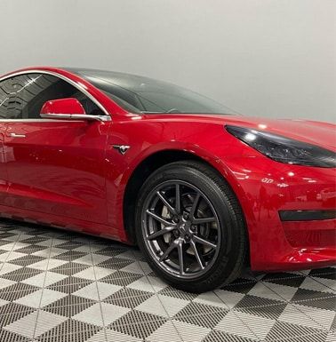 Automotive detailing shop red car alternate side view